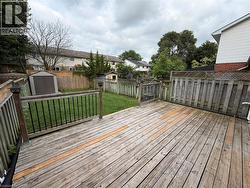 Spacious wood-finish deck with black metal balusters and post-top lighting -