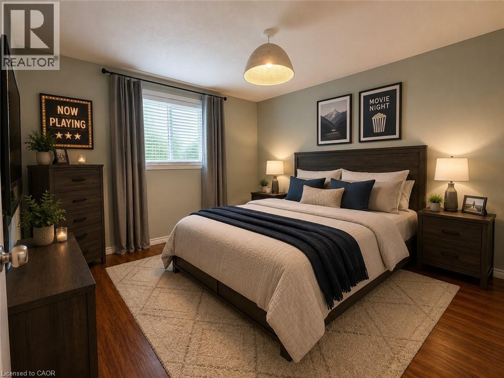 Spacious bedroom featuring wood-finish flooring, a contemporary ceiling light fixture, and a window with blinds - 41 Edgemere Drive, Cambridge, ON - Indoor Photo Showing Bedroom