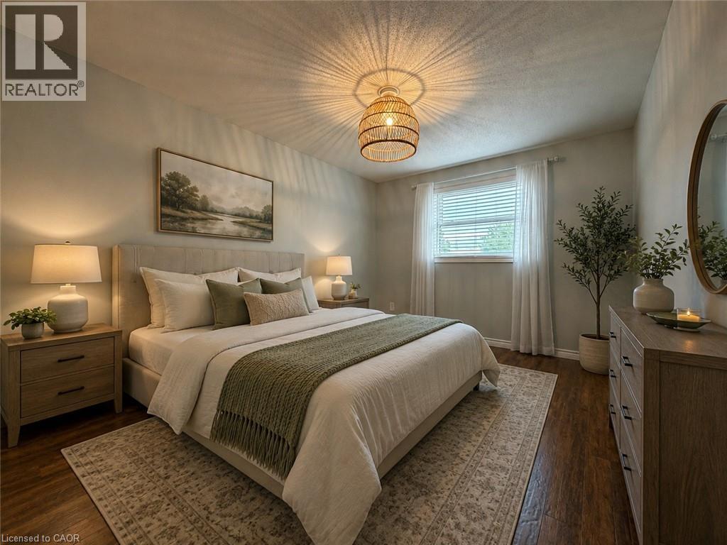 Bedroom featuring wood-finish flooring, a window with blinds and sheer curtains, a woven pendant light fixture, and light-toned walls - 41 Edgemere Drive, Cambridge, ON - Indoor Photo Showing Bedroom