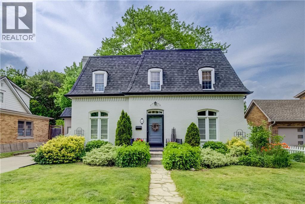 White brick exterior with a dark gray gambrel roof - 314 Glasgow Street, Kitchener, ON - Outdoor