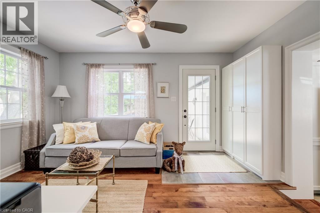 Living area featuring wood-finish flooring, light grey wall paint, and a ceiling fan with integrated lighting - 314 Glasgow Street, Kitchener, ON - Indoor Photo Showing Living Room