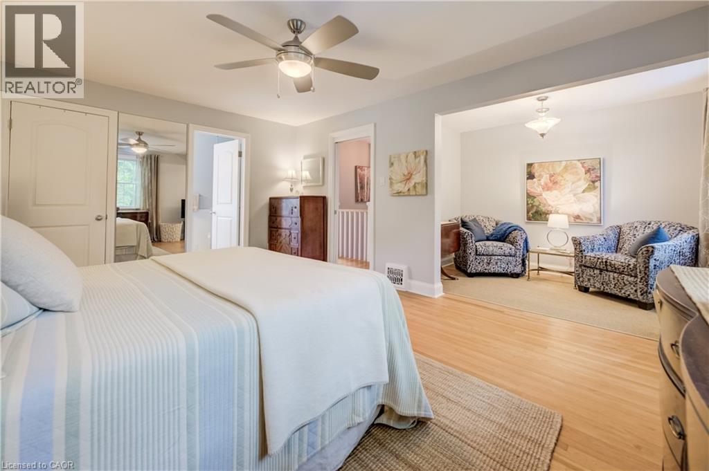 Bedroom featuring wood-finish flooring, ceiling fan with integrated lighting, and direct access to an additional living space - 314 Glasgow Street, Kitchener, ON - Indoor Photo Showing Bedroom
