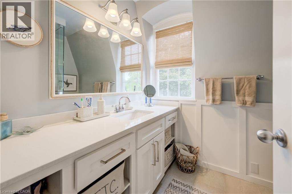 Vanity area featuring a wide countertop, integrated sink, and white cabinetry with brushed nickel hardware - 314 Glasgow Street, Kitchener, ON - Indoor Photo Showing Bathroom