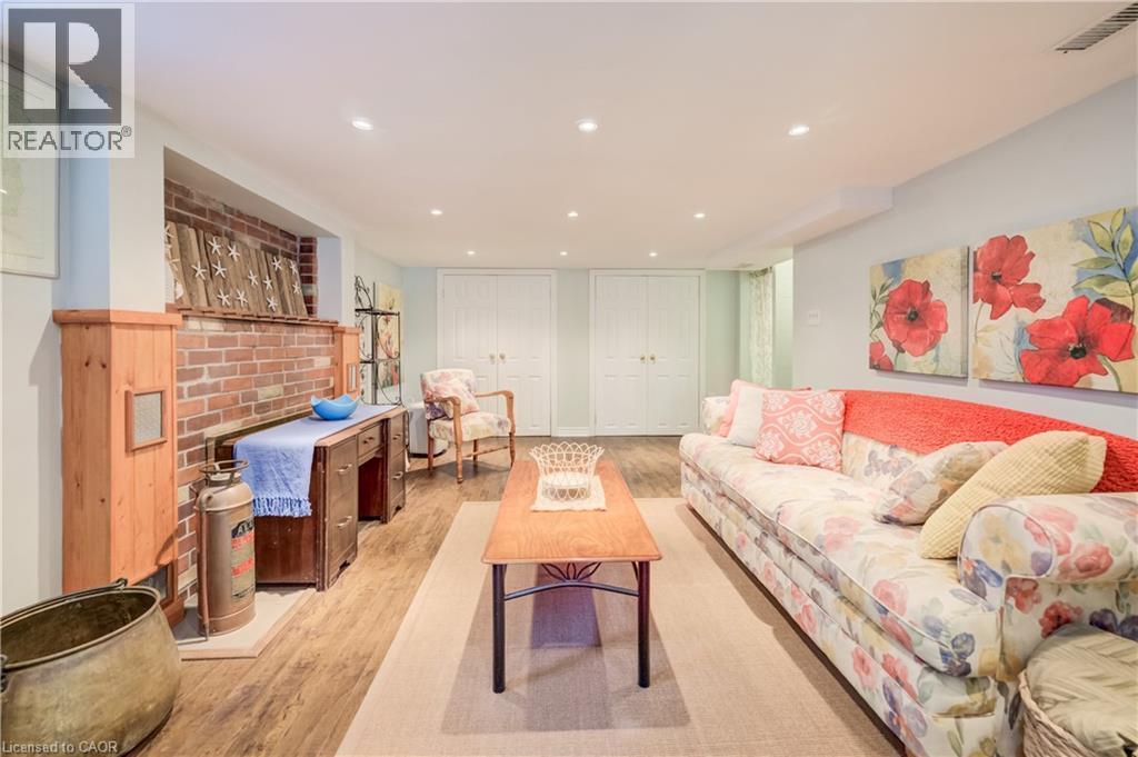 Living area featuring wood-finish flooring, recessed lighting, and a brick fireplace with a wood mantel - 314 Glasgow Street, Kitchener, ON - Indoor Photo Showing Living Room
