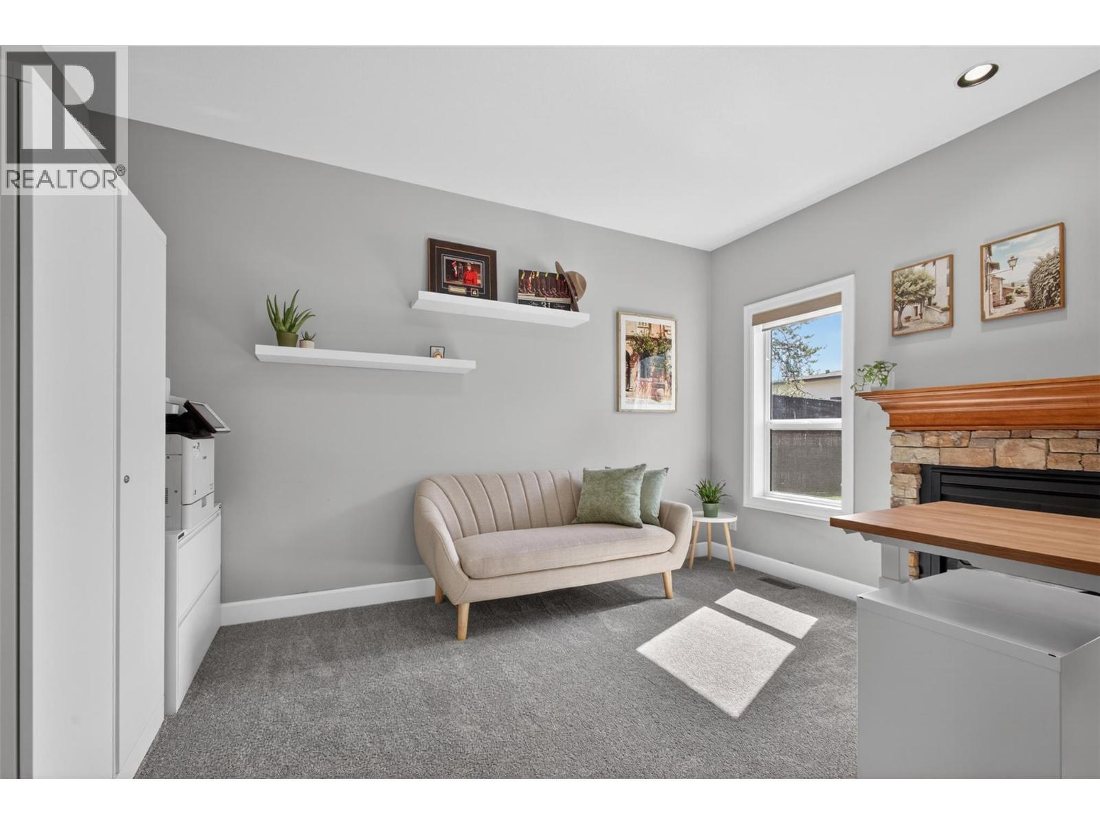 office - 4588 Raymer Road, Kelowna, BC - Indoor Photo Showing Living Room With Fireplace