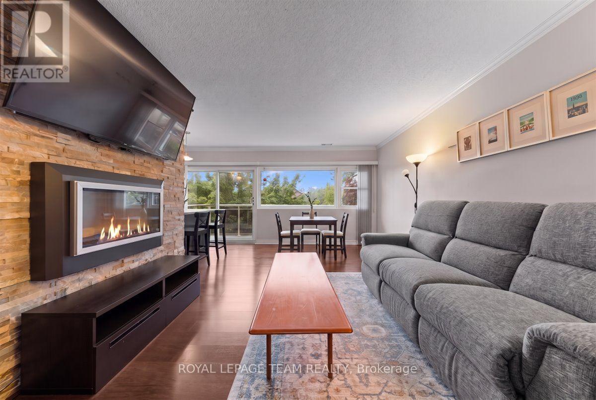 201 - 12 Corkstown Road, Ottawa, ON - Indoor Photo Showing Living Room With Fireplace