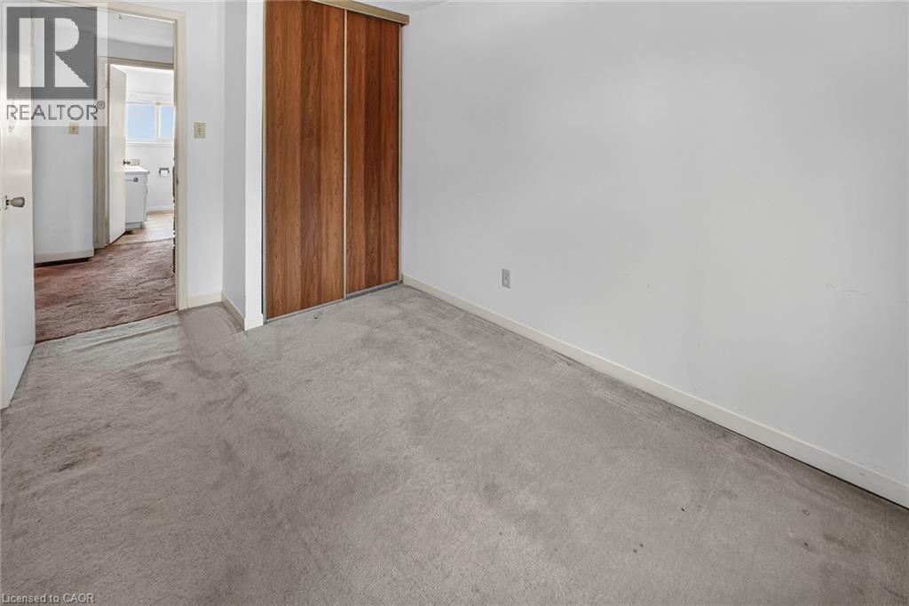 Light gray carpeted flooring paired with white walls - 125 Bonaventure Drive Unit# 50, Hamilton, ON - Indoor Photo Showing Other Room