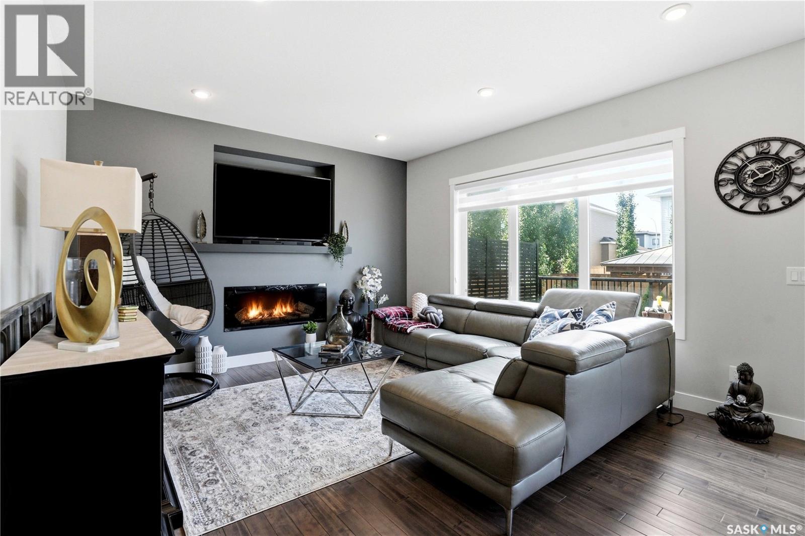 206 Kenaschuk Union, Saskatoon, SK - Indoor Photo Showing Living Room With Fireplace