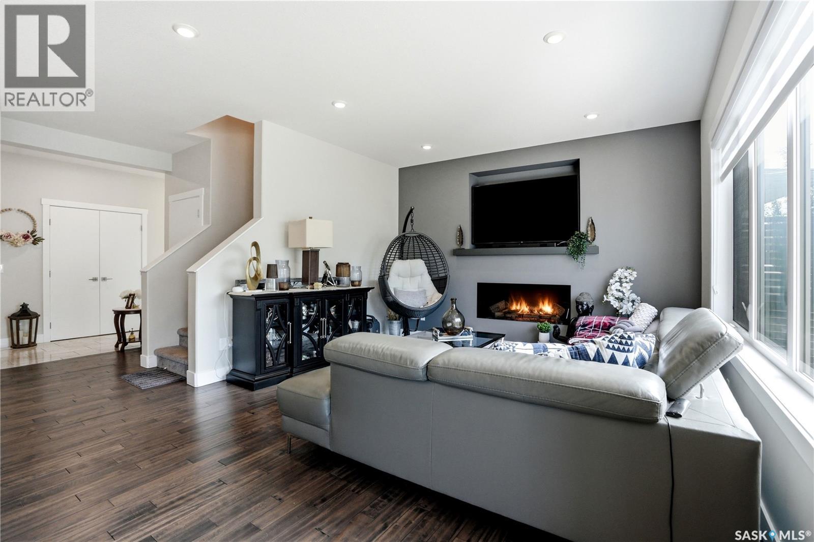 206 Kenaschuk Union, Saskatoon, SK - Indoor Photo Showing Living Room With Fireplace