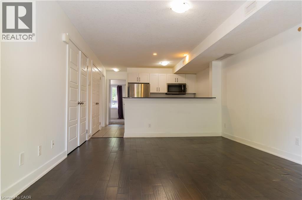 Open-concept living area with dark wood-finish flooring - 190 Century Hill Drive Unit# A5, Kitchener, ON - Indoor