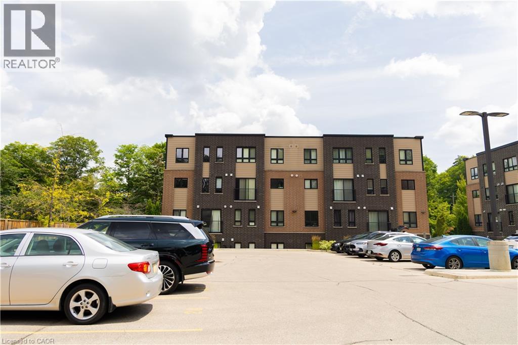 Modern multi-level building featuring a dark brick facade with contrasting light-toned paneling and multiple windows - 190 Century Hill Drive Unit# A5, Kitchener, ON - Outdoor