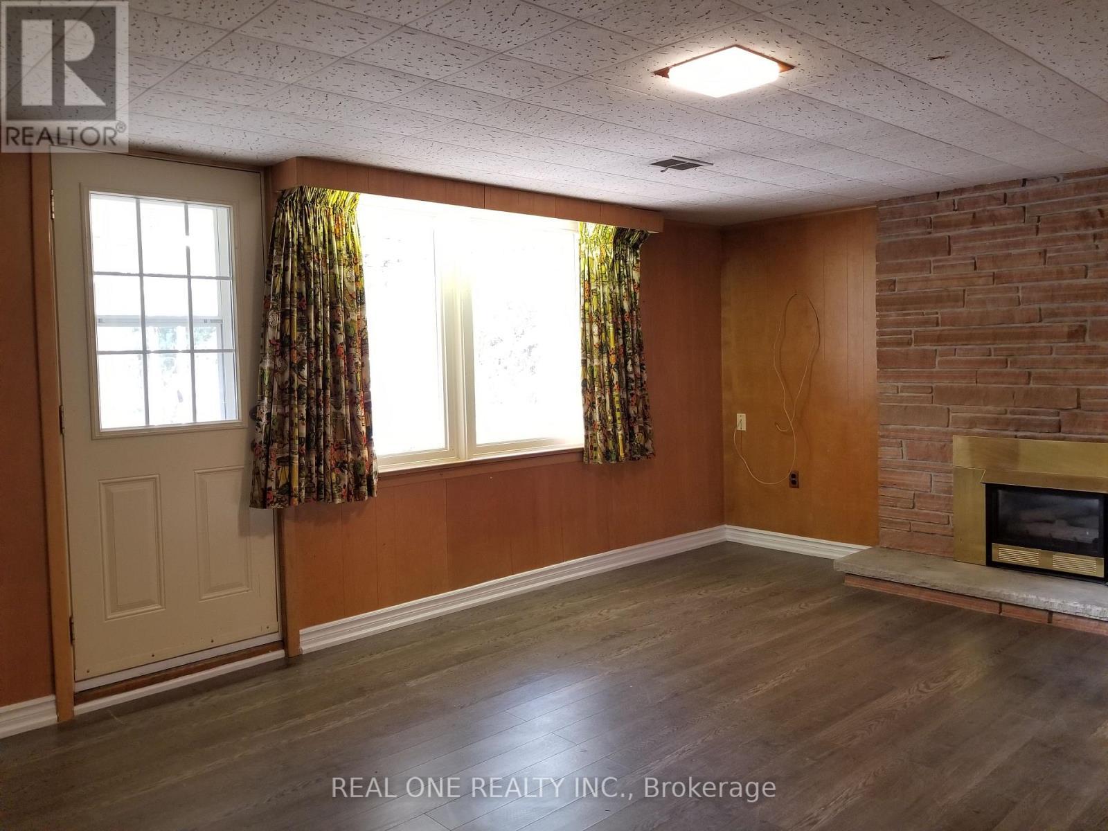Basement Living Room - 26 Applefield Drive, Toronto, ON - Indoor With Fireplace