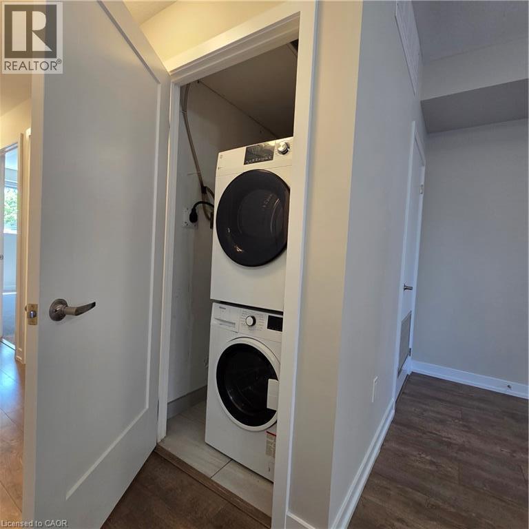 Dedicated laundry closet featuring a stacked washer and dryer - 20 Palace Place Unit# E9, Kitchener, ON - Indoor Photo Showing Laundry Room