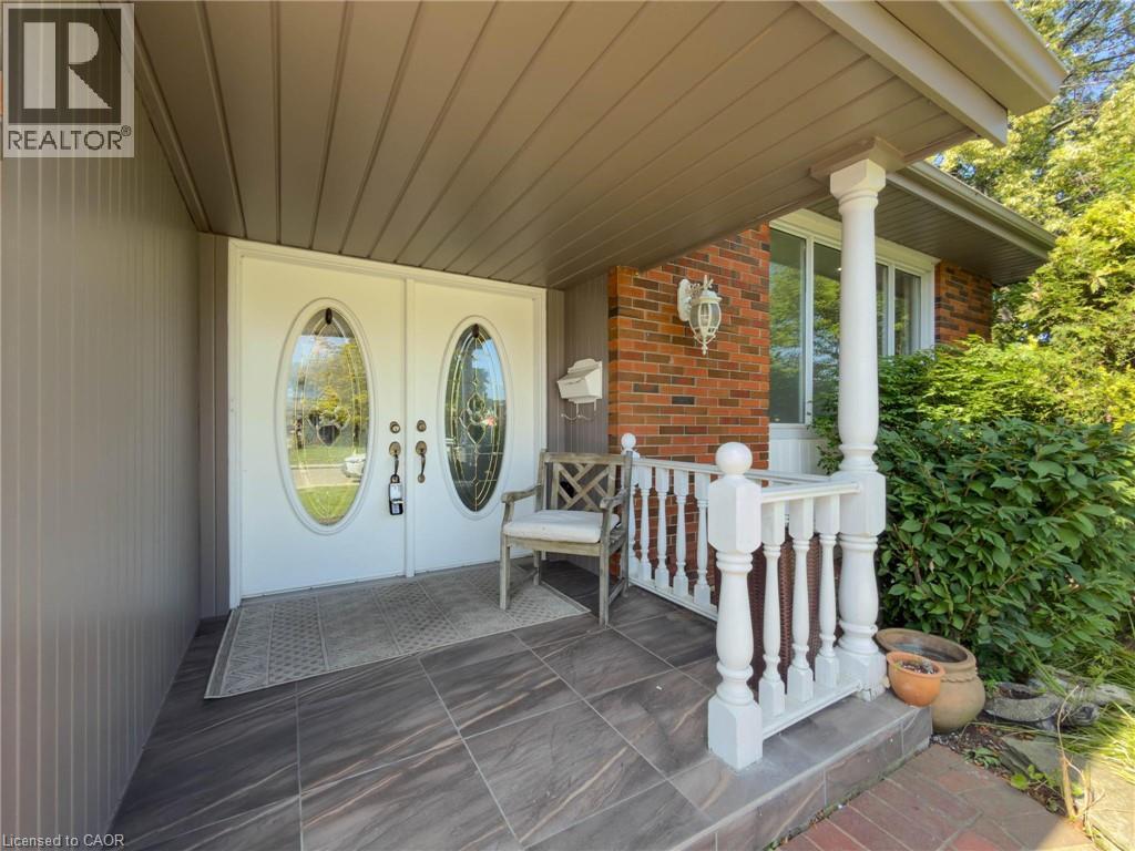 Front entry featuring double oval-paneled doors with decorative glass - 143 Cromwell Crescent, Hamilton, ON - Outdoor With Deck Patio Veranda With Exterior
