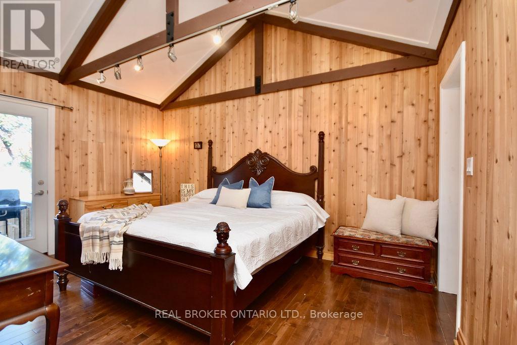 Primary w/walk out to water facing deck & ensuite - 5818 Victoria Park Road, Ramara, ON - Indoor Photo Showing Bedroom