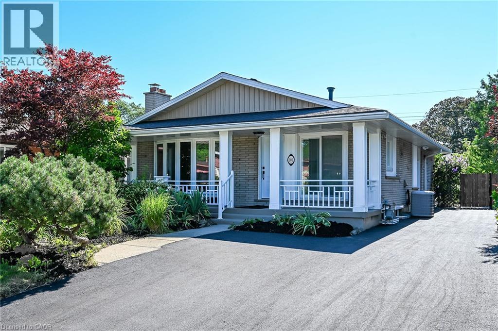 Brick and siding exterior with a covered front porch featuring white columns and railing - 101 Loyalist Drive, Hamilton, ON - Outdoor With Deck Patio Veranda