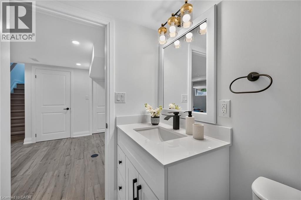 Bathroom vanity featuring a rectangular undermount sink, a matte black faucet, and a quartz countertop - 101 Loyalist Drive, Hamilton, ON - Indoor Photo Showing Bathroom