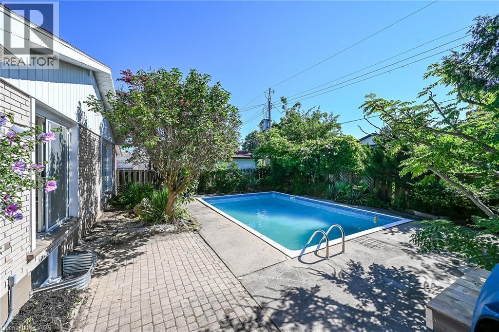 Rectangular inground pool with concrete surround - 101 Loyalist Drive, Hamilton, ON - Outdoor With In Ground Pool
