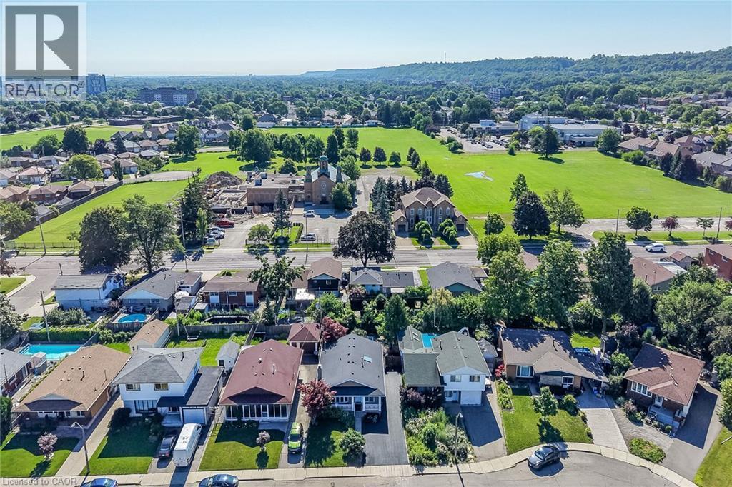 Aerial perspective showcasing a residential street with diverse architectural styles, individual driveways, and established landscaping - 101 Loyalist Drive, Hamilton, ON - Outdoor With View