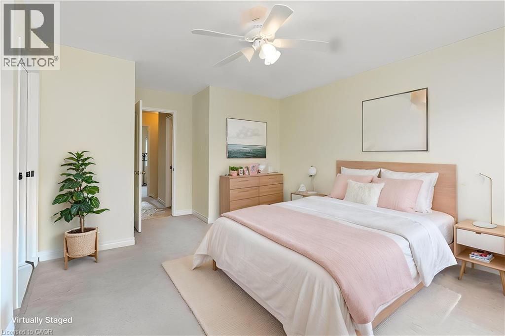 Bedroom featuring neutral carpeting, light-toned walls, and a ceiling fan with integrated lighting - 2248 Seton Crescent, Burlington, ON - Indoor Photo Showing Bedroom