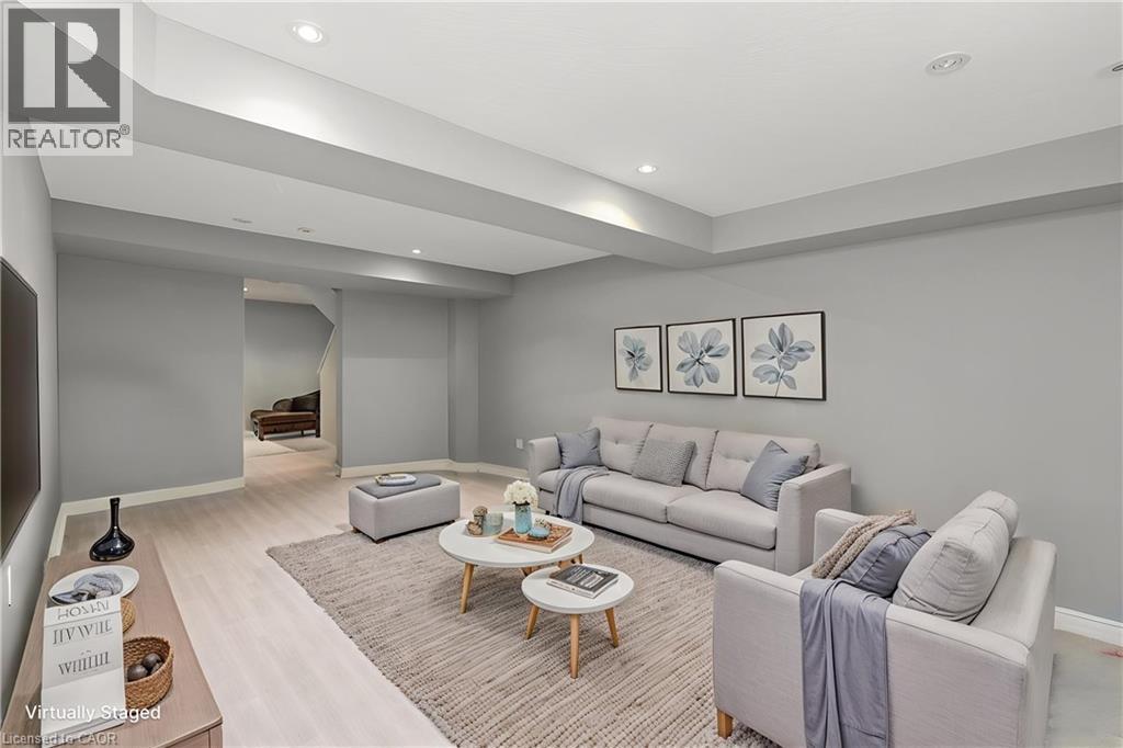 Spacious living area featuring light wood-finish flooring, recessed lighting, and neutral gray walls - 2248 Seton Crescent, Burlington, ON - Indoor Photo Showing Living Room