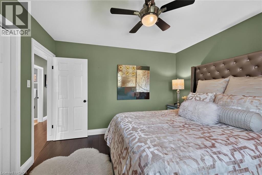 Bedroom featuring dark wood-finish flooring, olive green walls, and white trim - 386 Upper Kenilworth Avenue, Hamilton, ON - Indoor Photo Showing Bedroom