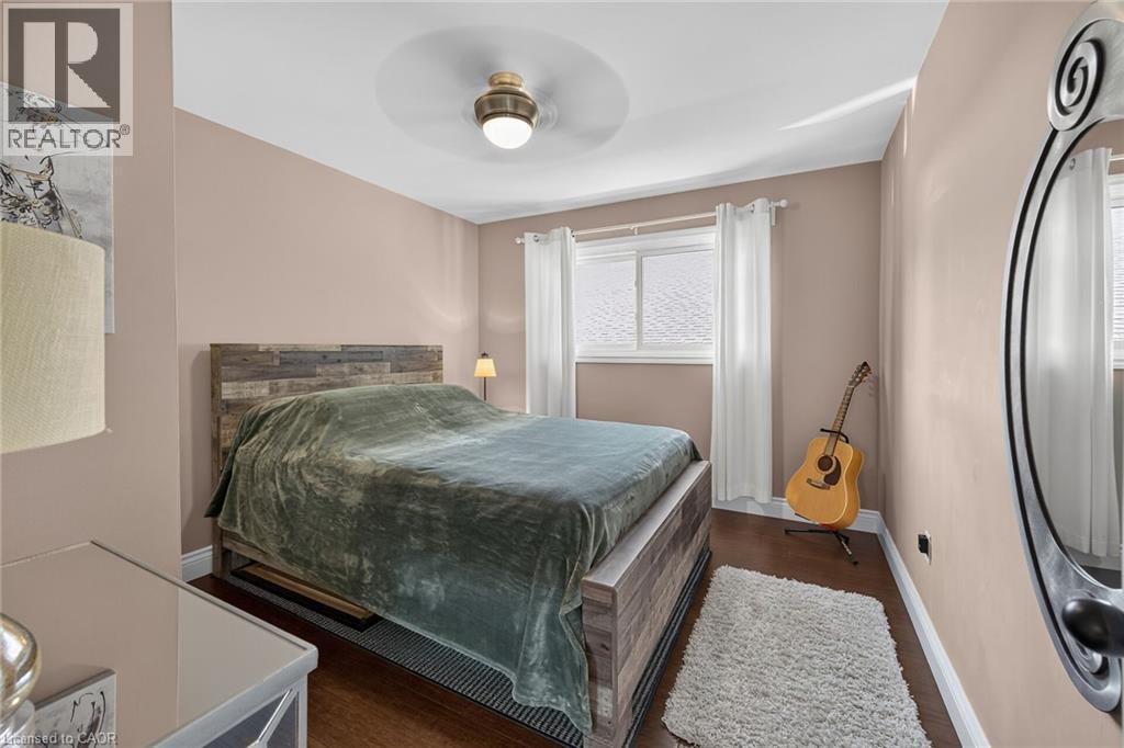 Room featuring wood-finish flooring, a contemporary ceiling fan, and painted walls - 386 Upper Kenilworth Avenue, Hamilton, ON - Indoor Photo Showing Bedroom