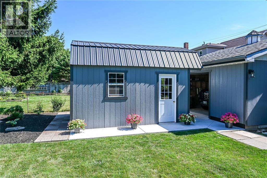 Detached shed featuring a metal roof, single window, and a white paneled door - 386 Upper Kenilworth Avenue, Hamilton, ON - Outdoor