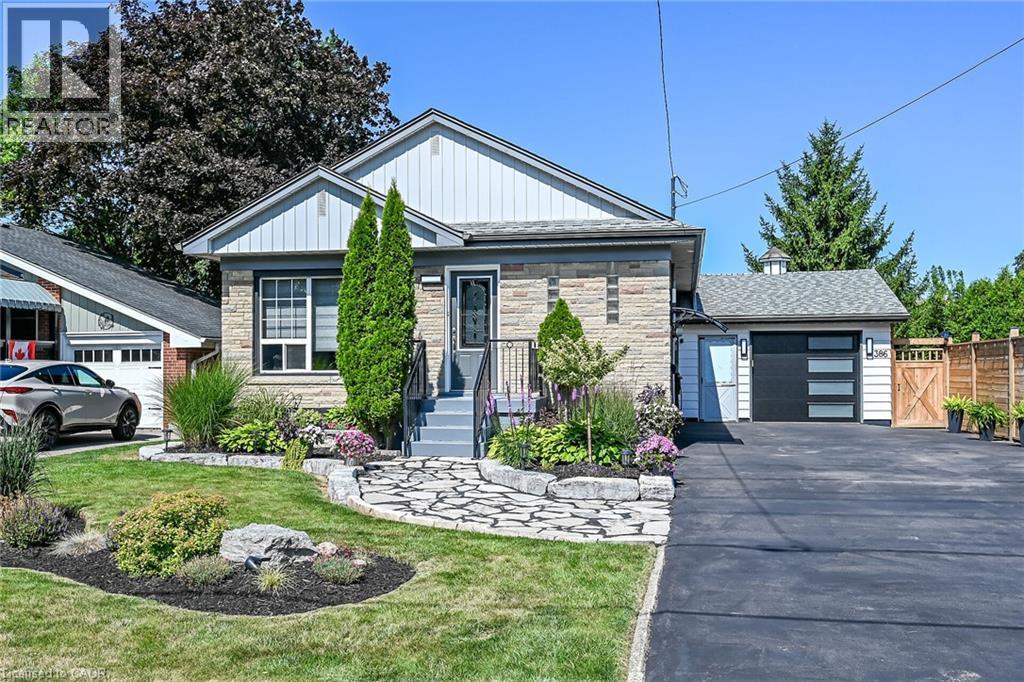 Stone and siding exterior with a dark gray front door and matching steps featuring black railings - 386 Upper Kenilworth Avenue, Hamilton, ON - Outdoor
