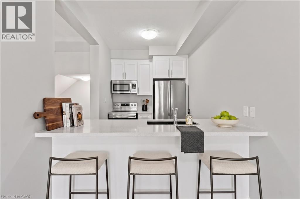 Virtually Staged Breakfast bar - 13 Aqua Lane, Hamilton, ON - Indoor Photo Showing Kitchen With Stainless Steel Kitchen