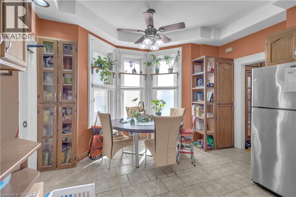 Bay window with white trim, recessed lighting, ceiling fan, tile flooring, and built-in wood-finish cabinetry - 17 Scarfe Avenue, Brantford, ON - Indoor