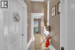 Interior hallway with neutral tone walls and white trim -