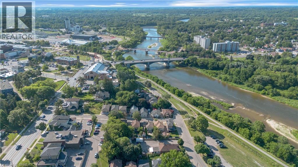 Aerial perspective showcasing a residential area alongside a river - 17 Scarfe Avenue, Brantford, ON - Outdoor With Body Of Water With View