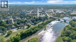 Aerial perspective showcasing a riverfront urban landscape with extensive tree canopy -
