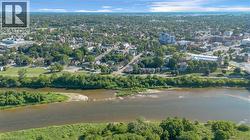 Aerial perspective showcasing a riverfront setting with surrounding urban and suburban development -