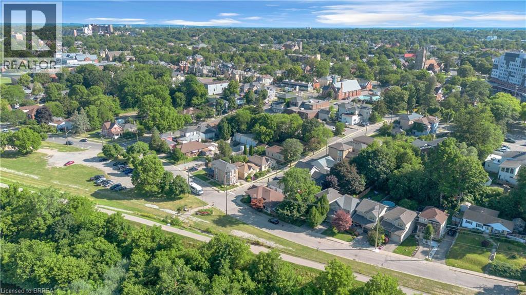 Expansive aerial perspective showcasing a residential neighborhood with mature tree coverage - 17 Scarfe Avenue, Brantford, ON - Outdoor With View