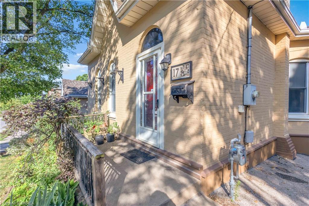 Brick exterior with arched entry door featuring stained glass accents - 17 Scarfe Avenue, Brantford, ON - Outdoor