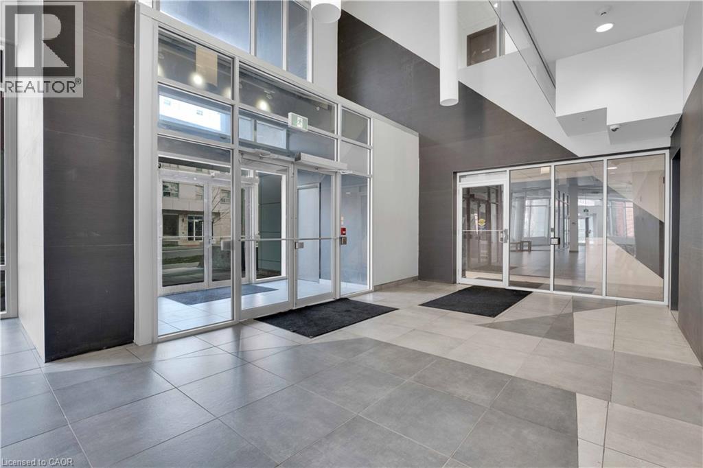 Contemporary lobby entrance featuring expansive glass doors and windows, providing abundant natural light - 158 King Street N Unit# 81201, Waterloo, ON - Indoor Photo Showing Other Room