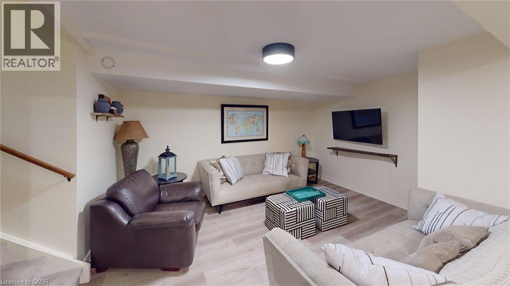 Spacious recreation room featuring light wood-finish flooring, recessed lighting, and neutral wall tones - 4101 Diana Park, Vineland, ON - Indoor Photo Showing Living Room