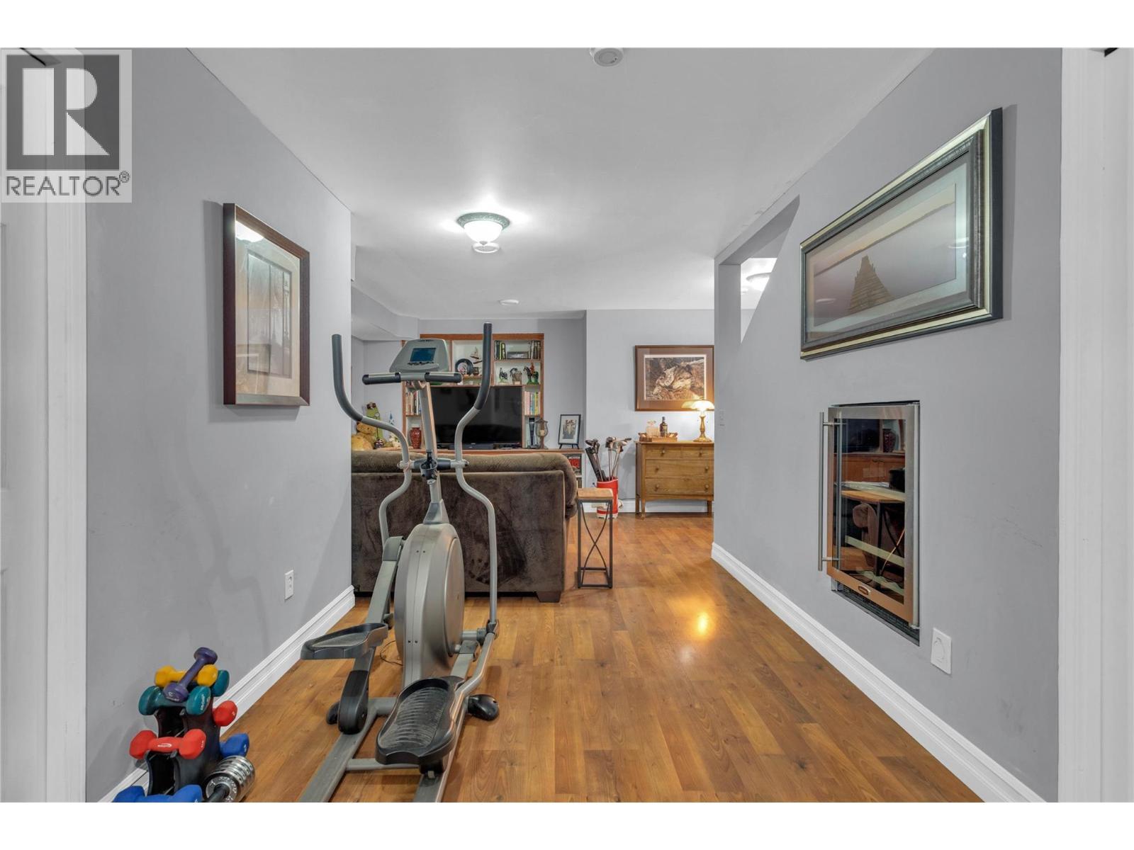 Family room viewed from the garage entry. - 430 Mccarren Avenue, Kelowna, BC - Indoor With Fireplace