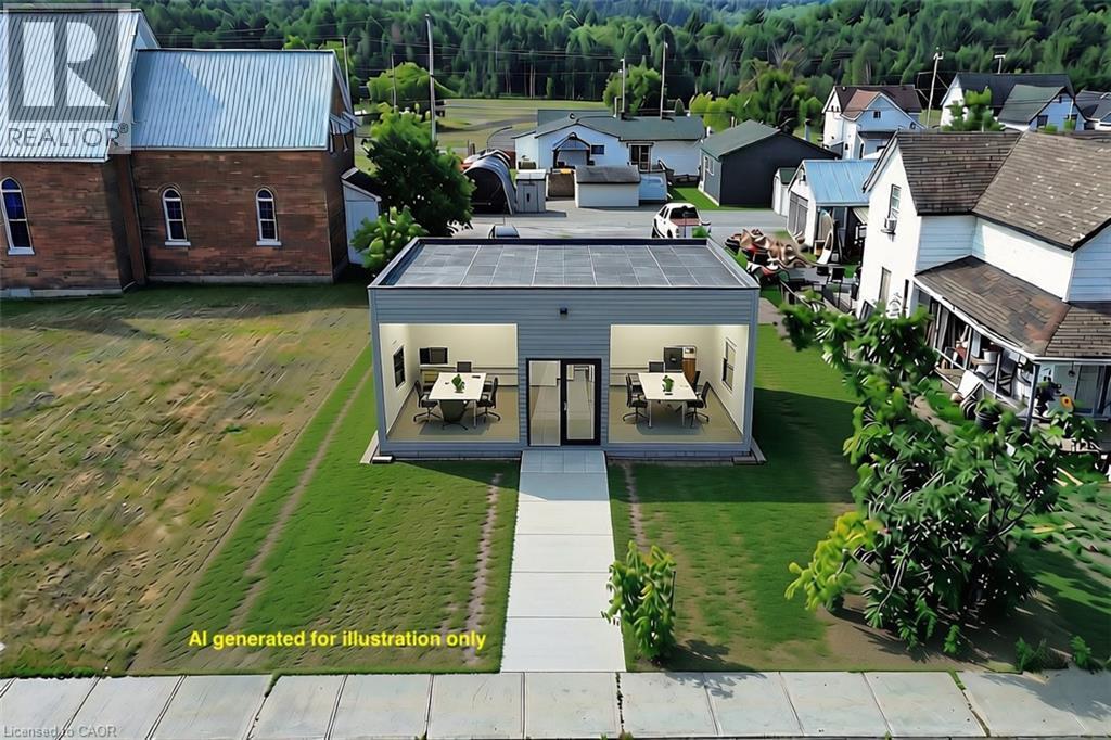 Modern commercial building featuring a flat roof and light gray siding - 33 Main Street, Webbwood, ON