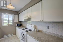 bright white cabinets and tile floor -