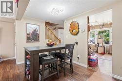 Dining area featuring wood-finish flooring and a built-in light fixture -