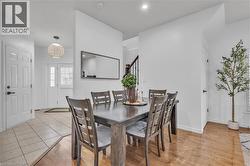 Dining area with wood-finish flooring, recessed lighting, and a neutral color palette -