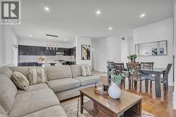 Open-concept living space featuring wood-finish flooring, recessed lighting, and a dining area -