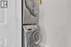 Stacked stainless steel laundry appliances -