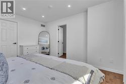 Bright interior space featuring light-colored walls and wood-finish flooring -