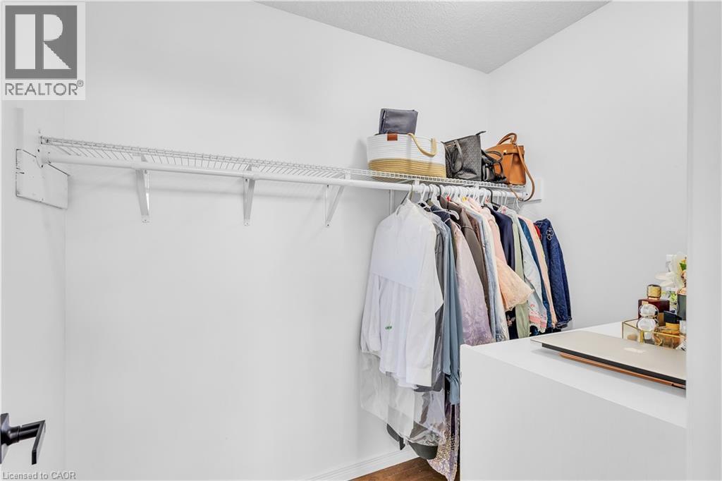 Walk-in closet featuring white wire shelving and hanging rod - 73 Fitzgerald Drive, Cambridge, ON - Indoor With Storage
