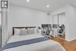 Room featuring wood-finish flooring, recessed lighting, and white walls -