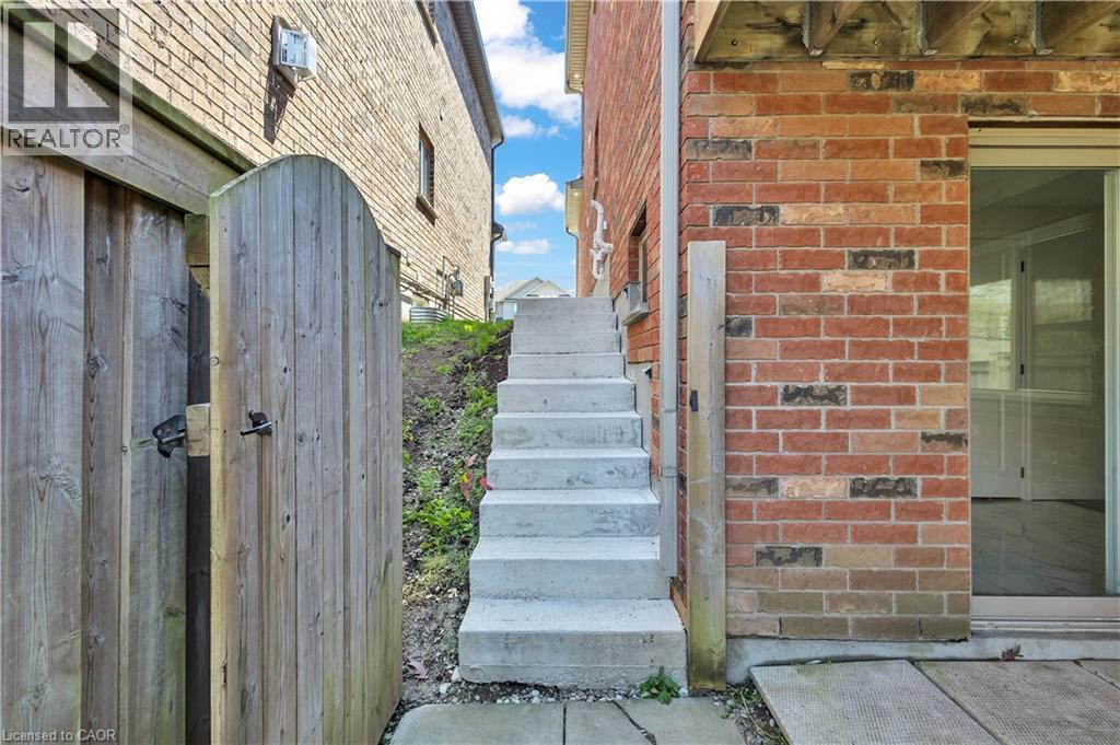 Brick exterior with concrete stairs accessing an upper level - 73 Fitzgerald Drive, Cambridge, ON - Outdoor With Exterior